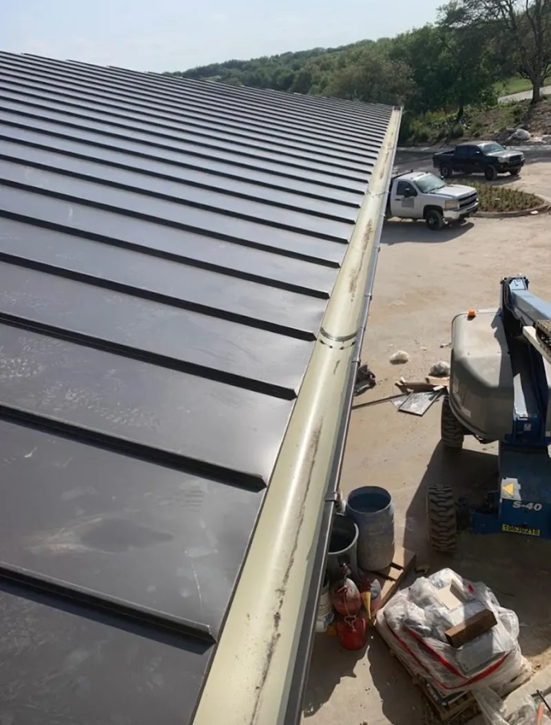 Standing seam panel and gutter detail on a metal roofing jobsite in Rosemead